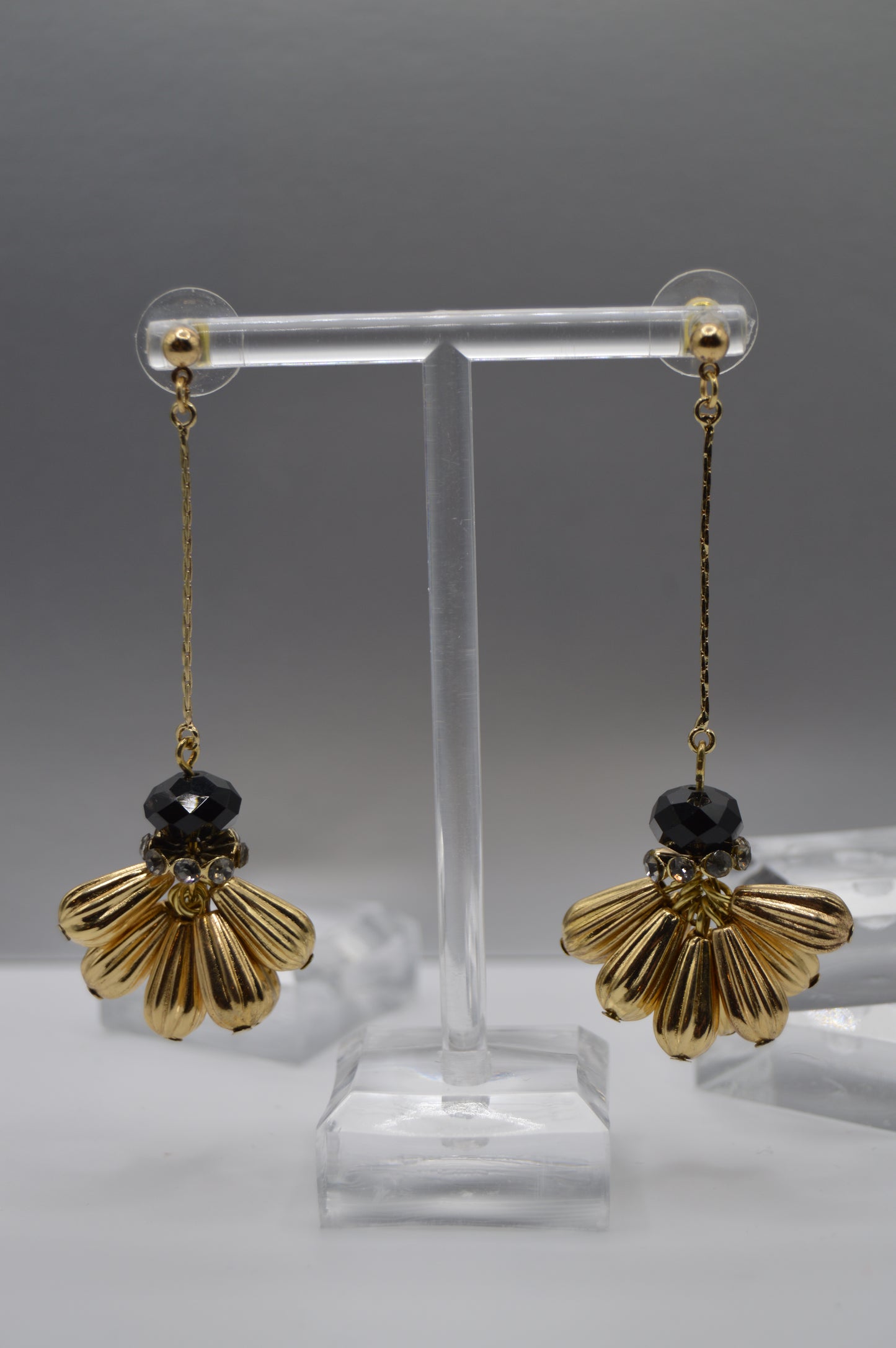 Gold Petal Drop Earrings ā Black Bead Accent
